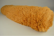 Langharig bont Okergeel